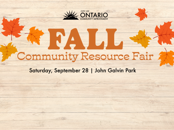 light wood background with various orange leaves text: "Fall Community Resource Fair John Galvin Park"